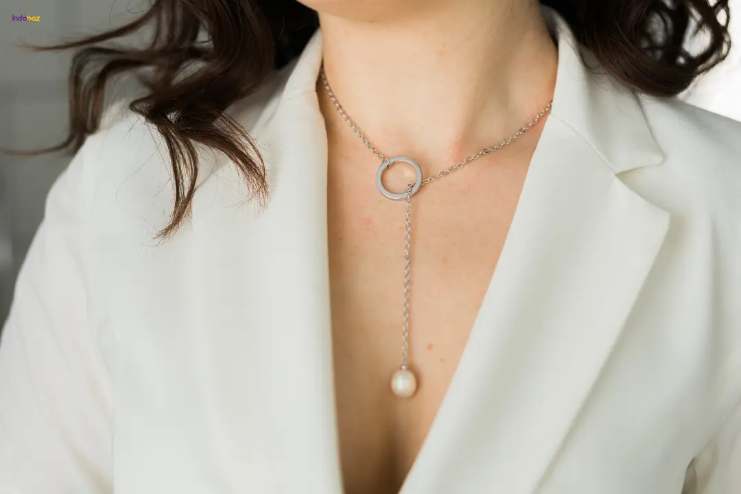 Woman accessorizing her outfit with layered jewelry – how to accessorize outfits