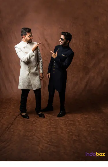 well-dressed men in varying kurta styles at a social event*