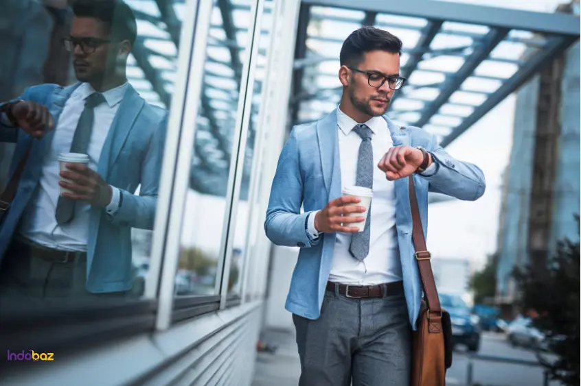 Man enjoying coffee wearing blazer and sunglasses